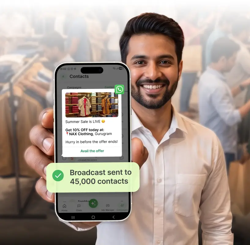 Showroom owner holding phone showing broadcast sent to 45,000 contacts on AiSensy
